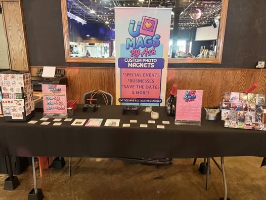 Photo magnet display table at an event by Ashley